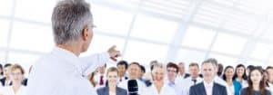 Businessmen giving a speech in front of audiences in the office