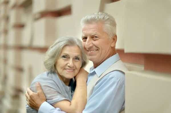 Elderly happy couple looking at camera