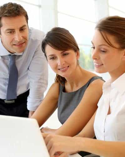 SIMM Associates, Inc. team looking out for a right candidate Group of businesspeople looking at laptop screen discussing work